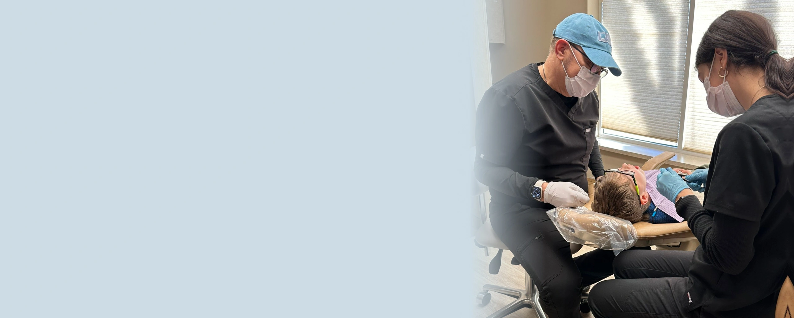 Orthodontist examining patient's teeth during dental consultation in clinical setting.